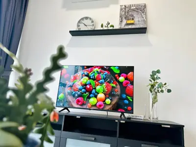 a flat screen tv sitting on top of a cabinet at Apartment in Georgetown 3BR-10pax in Jelutong