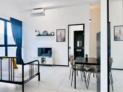 a dining room and living room with a table and chairs at Apartment in Georgetown 3BR-10pax in Jelutong