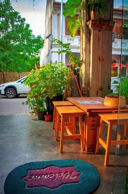 a table and a bench and a table and a rug at Rope Walk Guest House in George Town