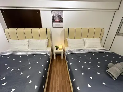 two beds sitting next to each other in a room at CEOZ1 Duplex 1BR Suite #Disneys HS #USM #SPICE in Bayan Lepas