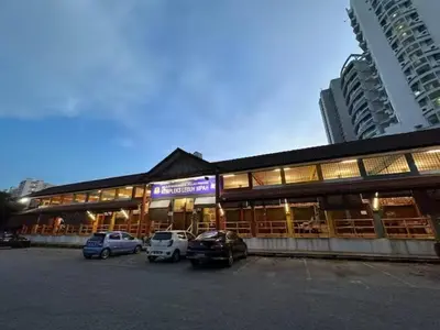 a building with cars parked in a parking lot at CEOZ1 Duplex 1BR Suite #Disneys HS #USM #SPICE in Bayan Lepas
