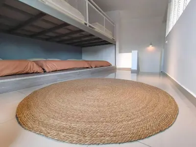 a large rug on the floor of a room with a bed at Morning de Ville-Private Pool BBQ Karaoke 26-30pax in Ipoh