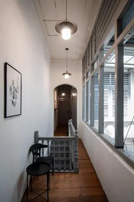 a hallway with a table and chairs in a building at Aayu Melayu - George Town Penang in George Town