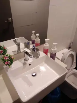 a bathroom with a white sink and a toilet at Rooftop - Sky Pool - 2BR Premium Homestay - Georgetown \u57ce\u5e02 6 pax in George Town