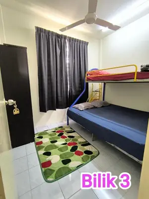 a bedroom with a bunk bed and a rug at Putra 2 Homestay in Gua Musang