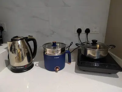 a kitchen counter with a blender and a tea kettle at ASC Smart Urban Suite Jelutong 2BR 3BR in Jelutong
