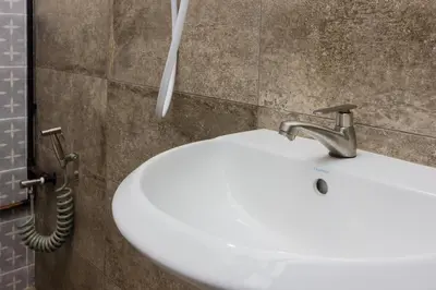 a white sink in a bathroom with a hose at Newly 5BR Cottage House Retreats (Free Parking) in Butterworth
