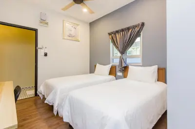 two beds in a room with a window at Newly 4BR Cottage House Retreats with Free Parking in Butterworth