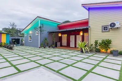 a colorful house with a courtyard in front of it at Newly 4BR Cottage House Retreats with Free Parking in Butterworth