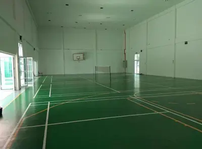 an empty gymnasium with a green basketball court at The Trails Kampar in Kampong Malim Nawar