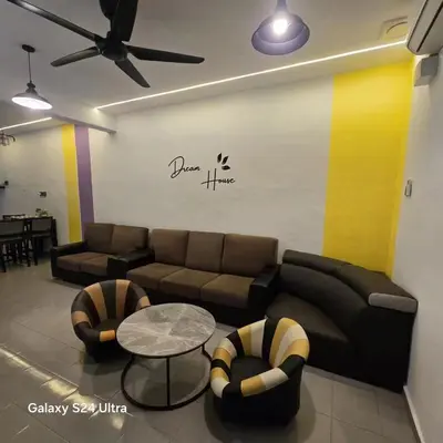 a living room with a couch and a table and chairs at 82,Dream Guest House in Tanjung Piandang