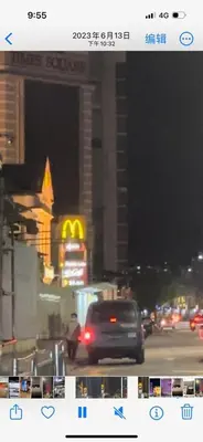 a car driving down a city street at night at GG 98 Hotel in George Town