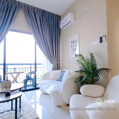a living room with a white couch and a plant at Ipoh Horizon Skypool Town Suites 4-11pax by IWH Suites in Ipoh