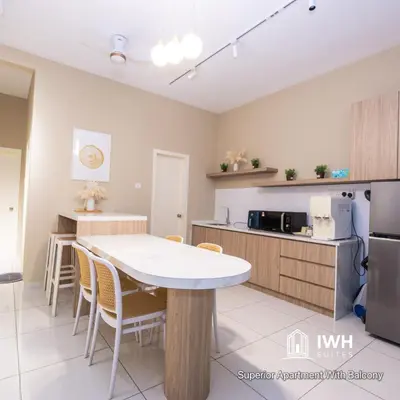 a kitchen with a table and chairs in a room at Ipoh Horizon Skypool Town Suites 4-11pax by IWH Suites in Ipoh