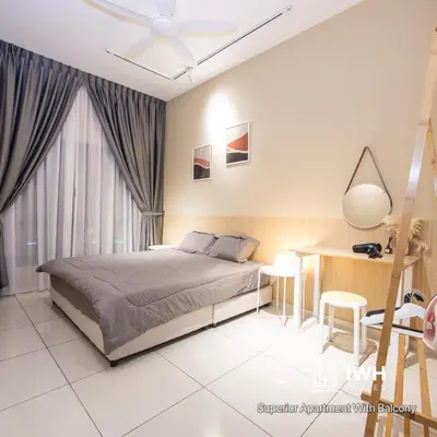 a bedroom with a bed and a desk and a ceiling fan at Ipoh Horizon Skypool Town Suites 4-11pax by IWH Suites in Ipoh