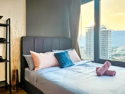 a bed in a room with a large window at Tropicana 218 Macalister by NGN in George Town