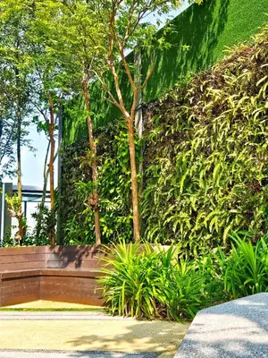 a bench in front of a wall with plants at Tropicana 218 Macalister by NGN in George Town