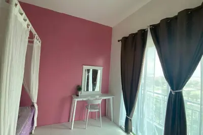 a pink room with a mirror and a table and a window at R&R Manjung Guest House at Pangsapuri Samudera in Seri Manjung