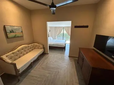 a living room with a couch and a bed at The Farmhouse in Ipoh