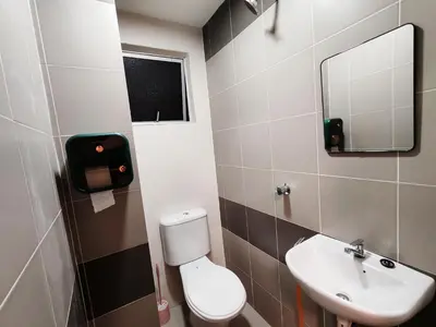 a bathroom with a toilet and a sink and a mirror at Pavilionvillie M1T696 by irainbow in Ipoh