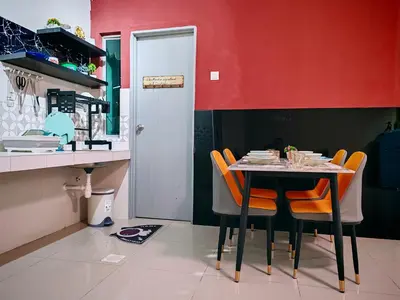 a dining room with a table and orange chairs at Pavilionvillie M1T695 by irainbow in Ipoh