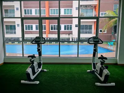 two exercise bikes in a room with a large window at Pavilionvillie M1T695 by irainbow in Ipoh