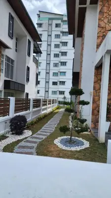 a walkway with a tree in the middle of a building at Zinnia Residence in Tanah Rata
