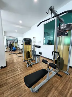 a gym with several treadmills and machines in a room at Modern Suite in Penang Island in Jelutong