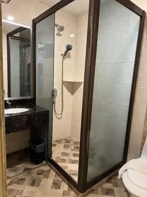 a bathroom with a shower and a sink at K Garden Hotel (BS) in Bagan Serai