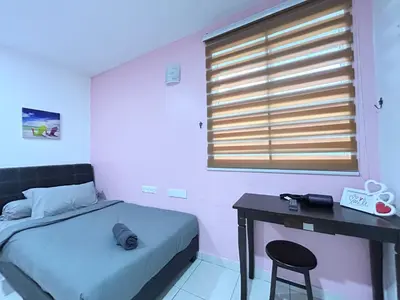 a bedroom with a bed and a desk and a window at Comfortable Homestay Ipoh 6R6B 9pax SY30 in Ipoh