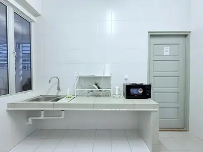 a white kitchen with a sink and a window at The Ximplicity @ Venus Residence Sitiawan Manjung in Sitiawan