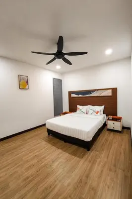 a bedroom with a bed with a ceiling fan at ZINNIA RESIDENCE in Tanah Rata
