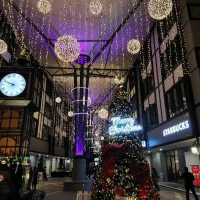 a christmas tree in a shopping mall with a clock at ALEESYA Homestay at Emerald Avenue Brinchang in Brinchang