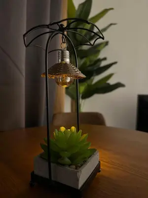 a lamp sitting on top of a table with a plant at Prima Falim in Ipoh