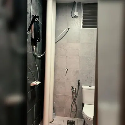 a bathroom with a shower and a toilet at Prima Falim in Ipoh