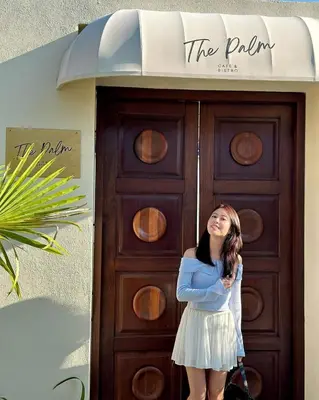 a young girl standing in front of a door at The Palm Suite Tanjung Tokong in George Town