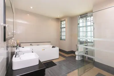 a bathroom with two sinks and a bath tub at Tanjung Bungah 5BR 18 Bungalow KTV in Tanjung Bungah