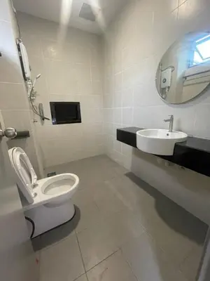 a bathroom with a toilet and a sink at Adik aisyah teres golden hill Cameron Highlands in Brinchang