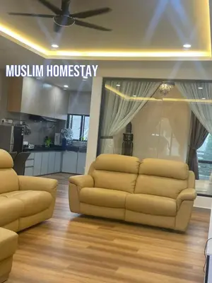 a living room with a couch in front of a kitchen at Adik aisyah teres golden hill Cameron Highlands in Brinchang