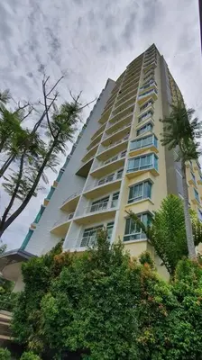 a tall white building with trees in front of it at Sky Residence -3 Bedrooms Condo at Cinta Sayang, Sungai Petani in Sungai Petani