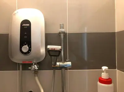 a soap dispenser on the wall of a bathroom at CLP Perai Homestay Apartment in Chai Leng park in Perai