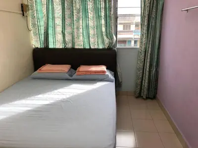 a small bed in a room with a window at CLP Perai Homestay Apartment in Chai Leng park in Perai