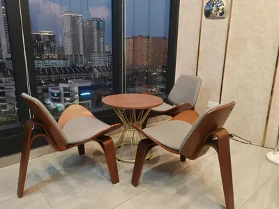 a room with three chairs and a table and a window at Seaview Urban suites Georgetown @Penang in Jelutong