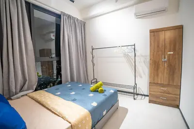 a bedroom with a bed with a teddy bear on it at Seaview Urban suites Georgetown @Penang in Jelutong