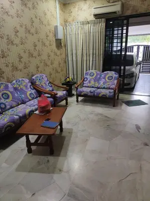 a living room with two couches and a coffee table at HomeStay Pulai in Ipoh