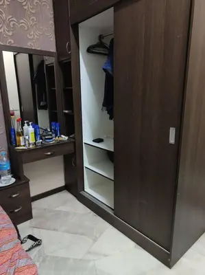 a walk in closet with a glass door and a closet at HomeStay Pulai in Ipoh