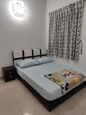 a bedroom with a large bed with a curtain at Casa Margosa Homestay in Ipoh