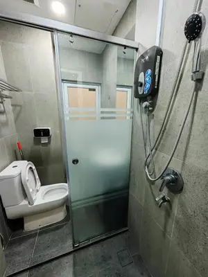 a bathroom with a shower stall with a toilet at Maritime Cozy Suite @ Penang Georgetown in Jelutong
