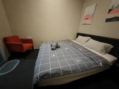 a stuffed animal laying on a bed in a room at Maritime Cozy Suite @ Penang Georgetown in Jelutong