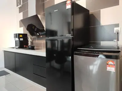 a kitchen with a stainless steel refrigerator in a kitchen at Dawn de Ville-Private Pool BBQ Karaoke 34-40pax in Ipoh